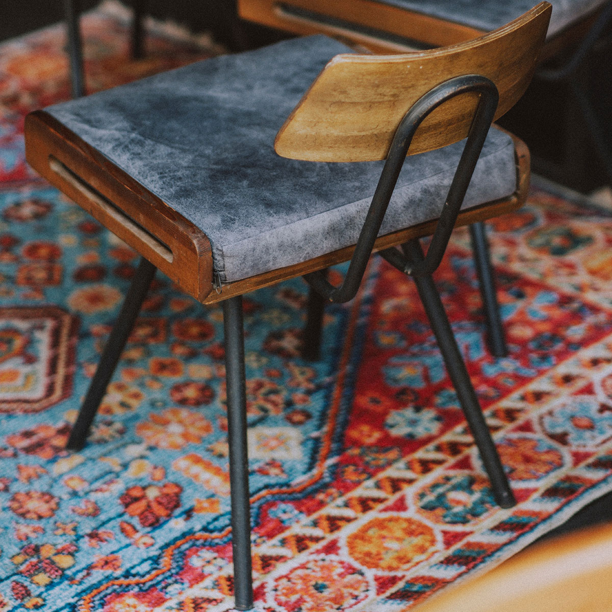 Overhead view of a camera capturing a chair on a carpet, symbolizing Nayyer Industries' transition from traditional to digital.